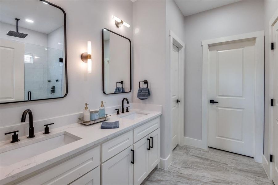 Bathroom with tile patterned flooring and double sink vanity