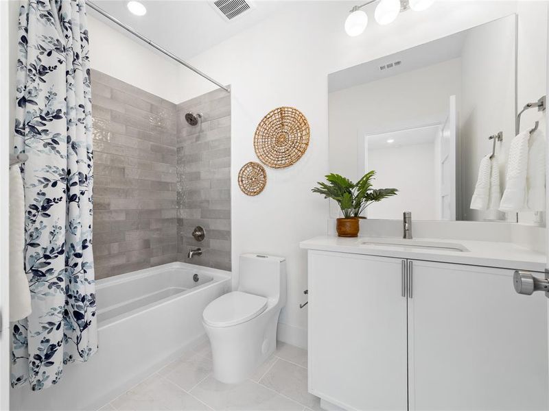 Bathroom with tile patterned flooring, vanity, shower / bath combo with shower curtain, and recessed lighting