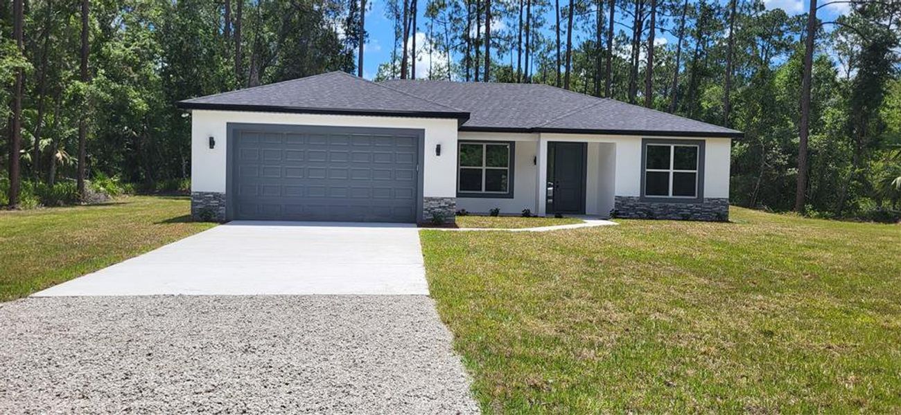 Front exterior of a new home in , Bunnell, FL, highlighting curb appeal (Image 2). Front exterior of a new home in , Bunnell, FL, highlighting curb appeal (Image 2).