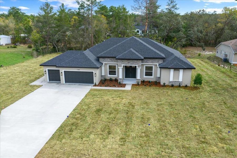 Front exterior of a new home in , Weeki Wachee, FL, highlighting curb appeal (Image 28).