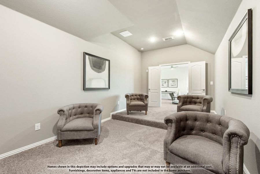 Sitting room with vaulted ceiling, carpet flooring, and four tufted gray accent chairs