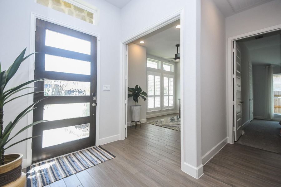 Natural lighting is a key feature throughout this home. Wood-look tile flooring is elegant and easy maintenance.