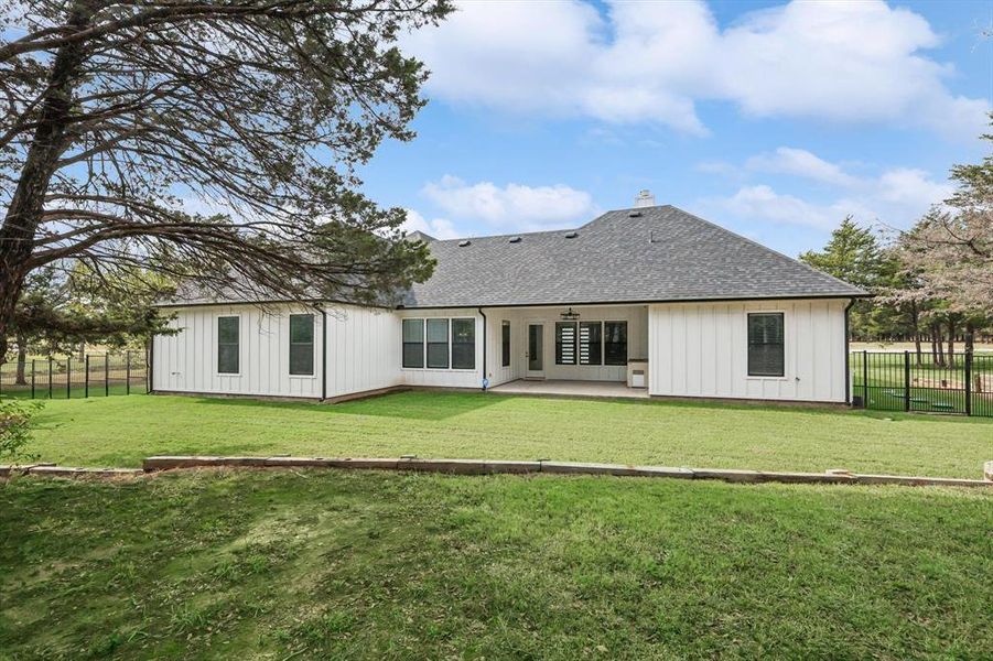 Back of property featuring a patio and a lawn