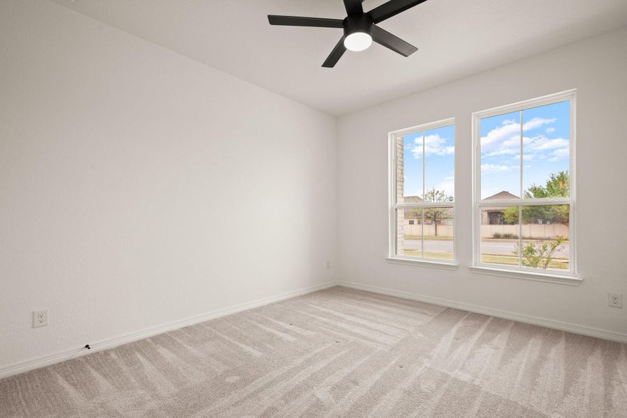 The secluded main floor guest room also overlooks the front yard and comes with a modern LED ceiling fan and closet storage. The secluded main floor guest room also overlooks the front yard and comes with a modern LED ceiling fan and closet storage.