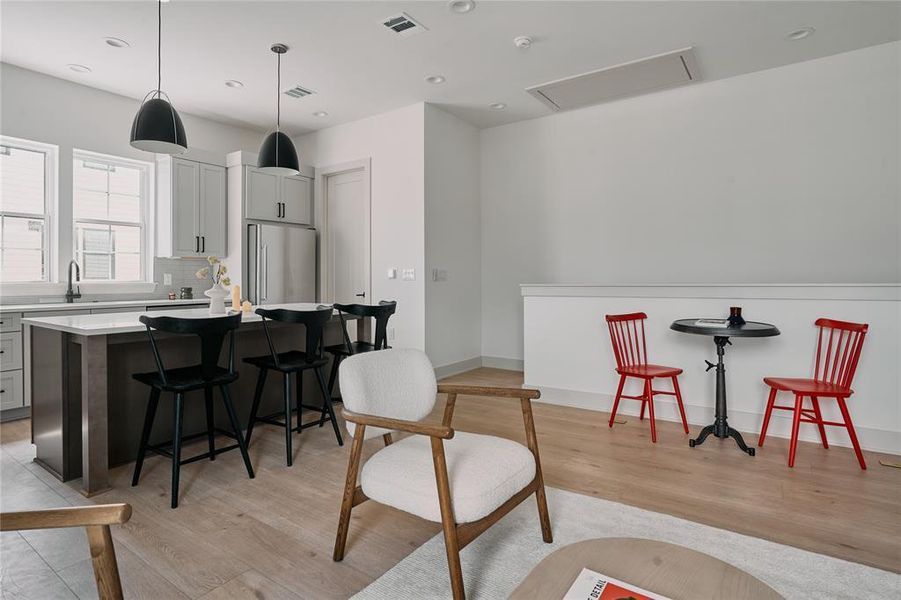 Open concept living area featuring wood-finish flooring