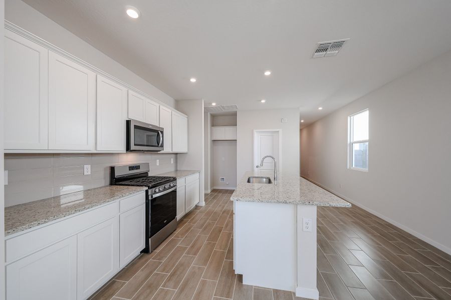 A kitchen with white cabinets. A kitchen with white cabinets.