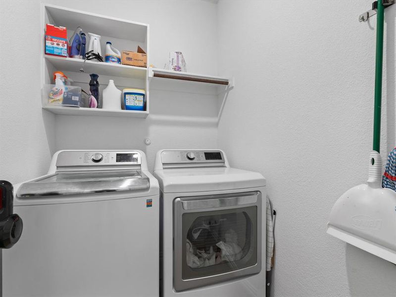 Washroom with washing machine and clothes dryer