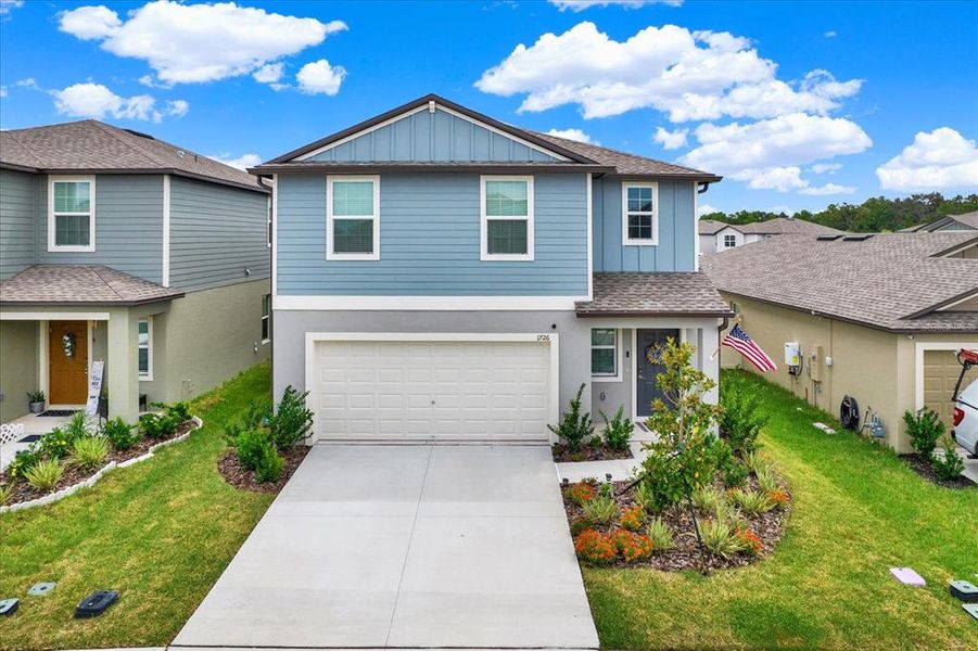 Front exterior of a new home in Two Rivers: The Manors II, Zephyrhills, FL, highlighting curb appeal (Image 1). Front exterior of a new home in Two Rivers: The Manors II, Zephyrhills, FL, highlighting curb appeal (Image 1).
