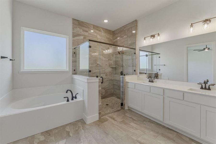 Bathroom featuring a separate soaking tub and a walk-in shower with glass enclosure Bathroom featuring a separate soaking tub and a walk-in shower with glass enclosure