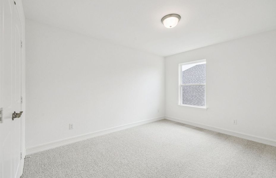 Spacious secondary bedroom features ample closet space  *Real home pictured