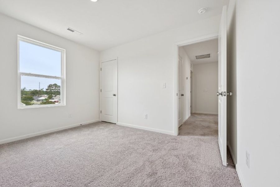 A room with white walls and a window. A room with white walls and a window.