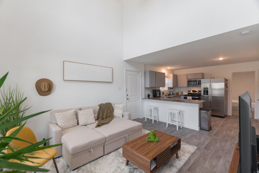 Spacious living room with natural light and luxury vinyl plank flooring Spacious living room with natural light and luxury vinyl plank flooring