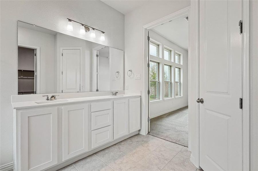 Bathroom with large vanity, tile flooring, and double sink