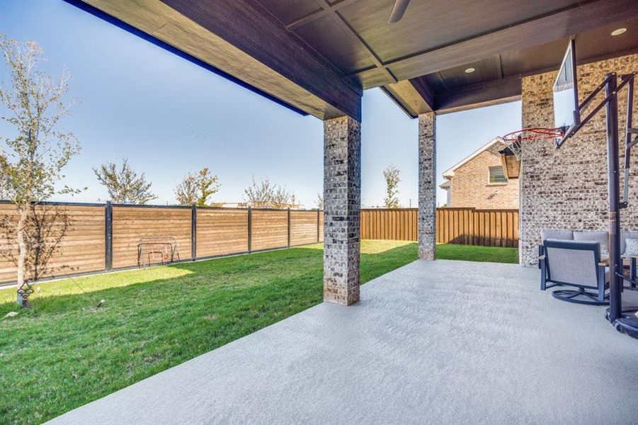 Fenced backyard featuring a patio