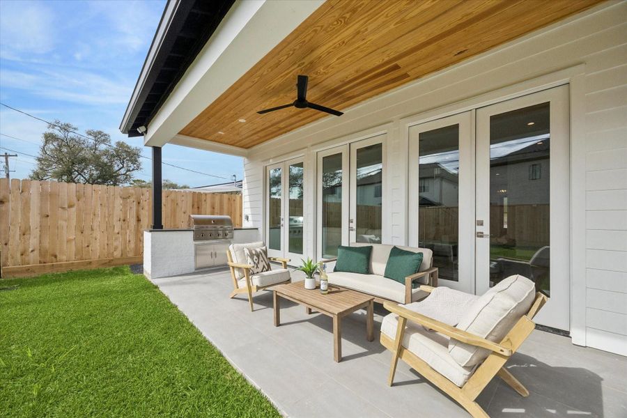 Covered outdoor living area perfect for dining, relaxing, or watching kids play in the yard.