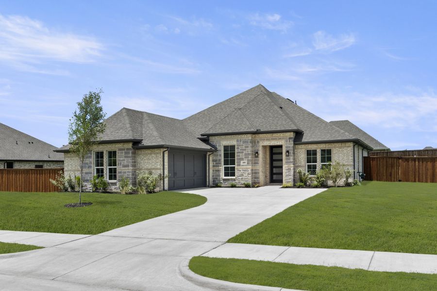 Front exterior of a new home in Lovers Landing, Forney, TX, highlighting curb appeal (Image 2). Front exterior of a new home in Lovers Landing, Forney, TX, highlighting curb appeal (Image 2).
