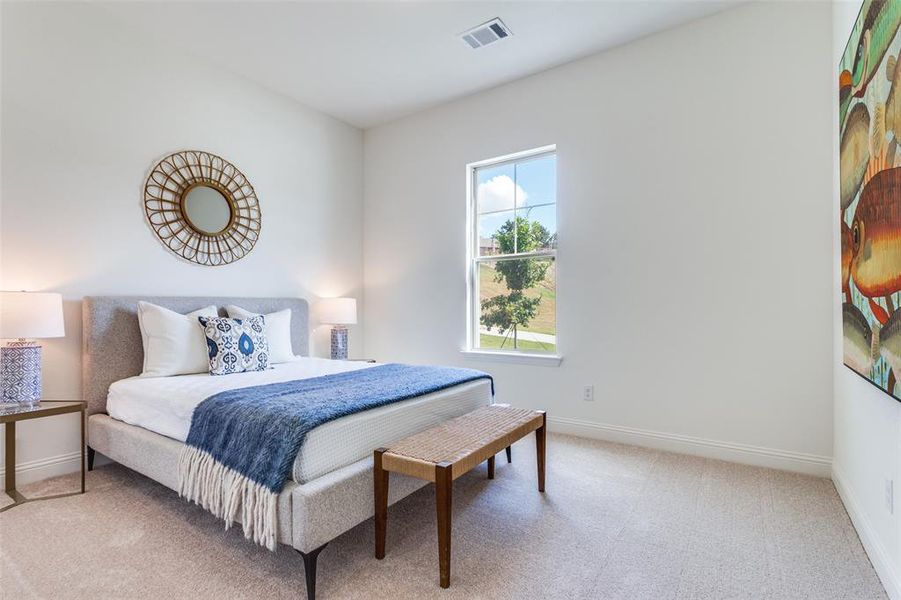 Bedroom featuring light carpet