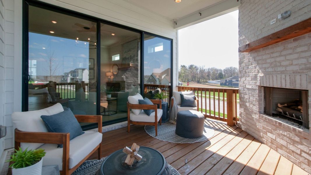 Covered indoor-outdoor seating area with fireplace Covered indoor-outdoor seating area with fireplace