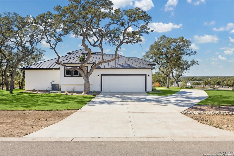 Front exterior of a new home in , Bulverde, TX, highlighting curb appeal (Image 28).