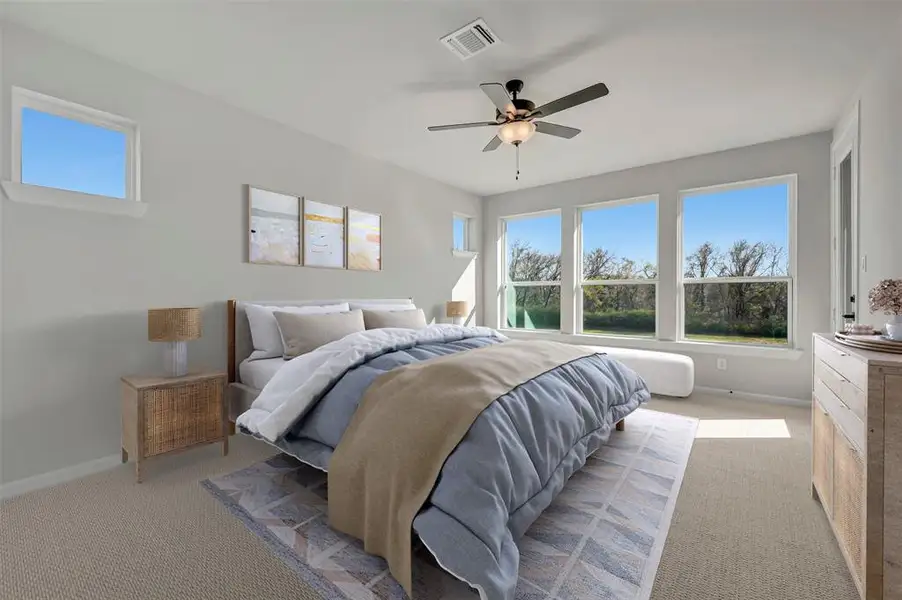 Bedroom with light colored carpet and a ceiling fan Bedroom with light colored carpet and a ceiling fan