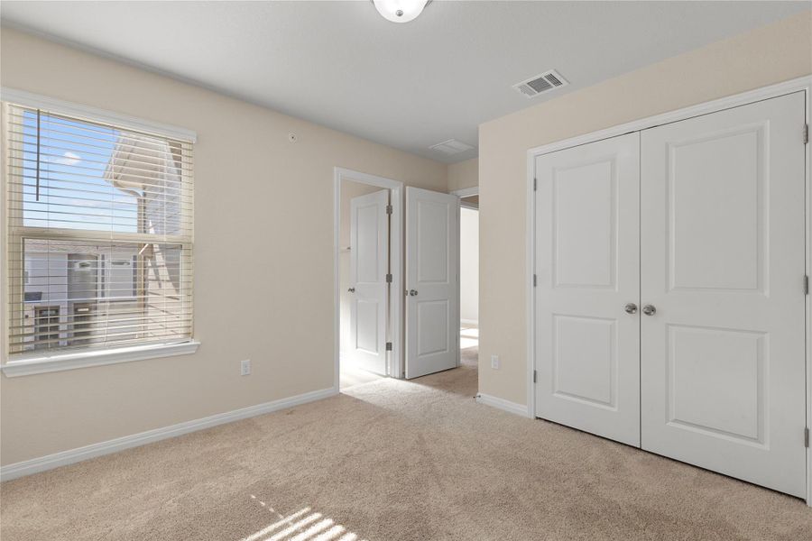 Carpeted bedroom -alt view with baseboards Carpeted bedroom -alt view with baseboards