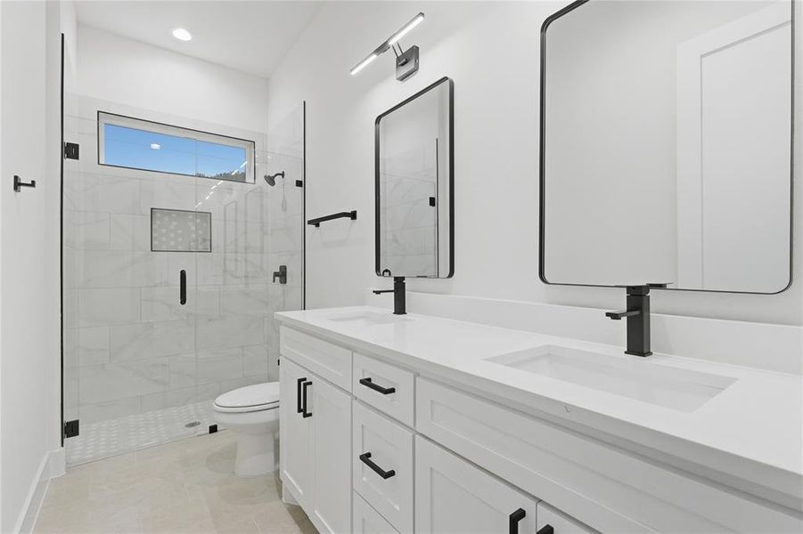 Bathroom with double vanity, a shower stall, recessed lighting, and light tile patterned floors