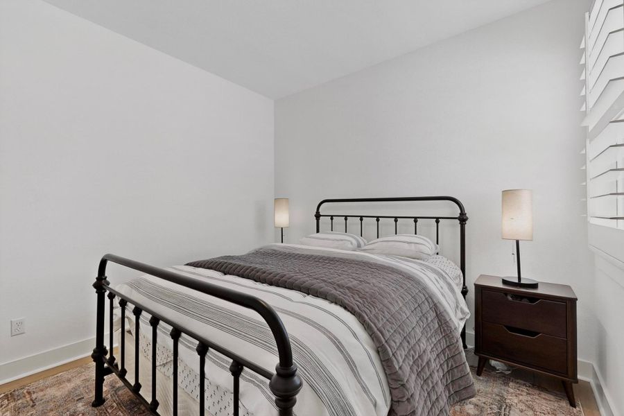 Bedroom featuring baseboards and wood finished floors