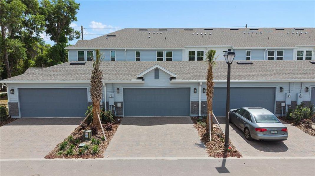 Front exterior of a new home in Aulin Square, Oviedo, FL, highlighting curb appeal (Image 25).