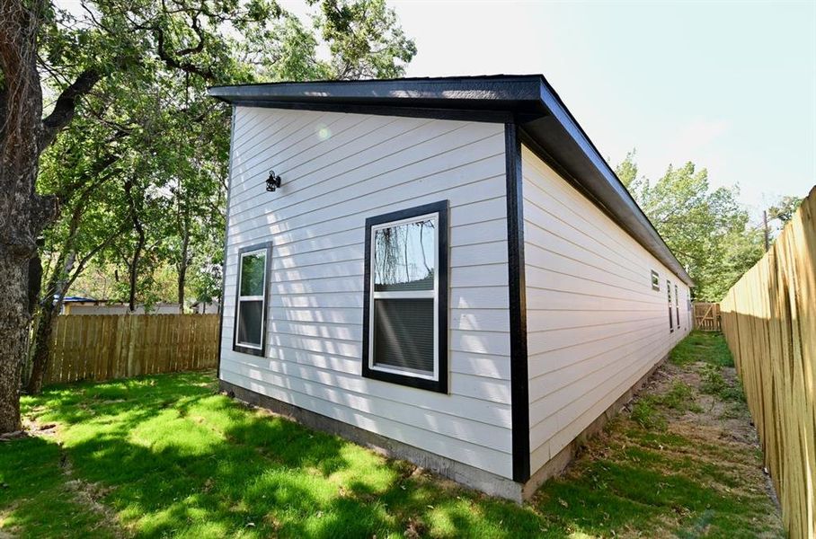 View of side of property with a yard