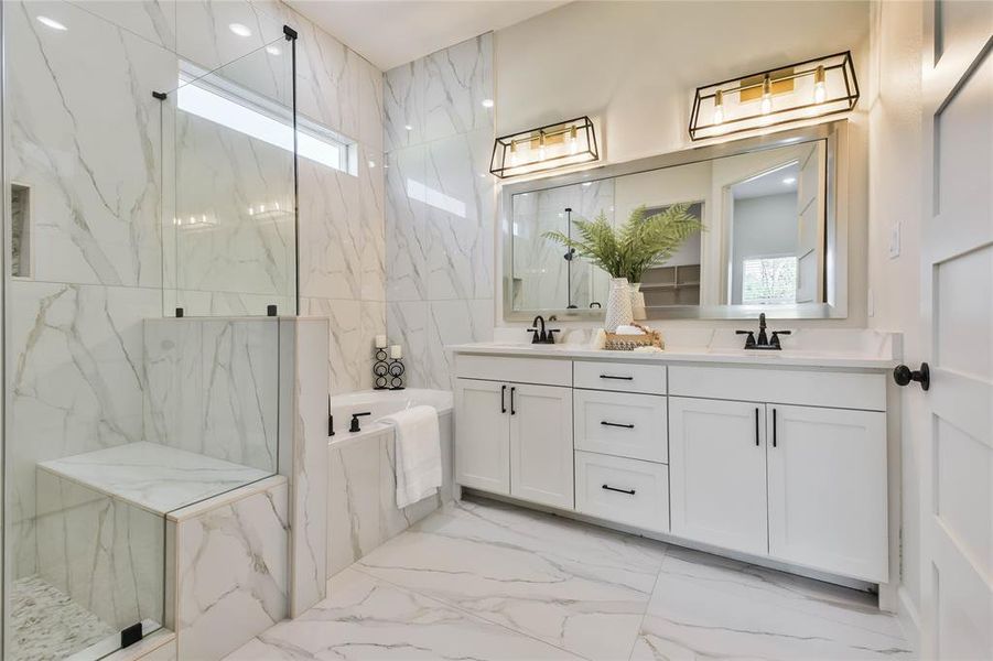 Take a look at this WOW Primary Bathroom with floor to ceiling accent wall, step in shower, tub and double vanity.