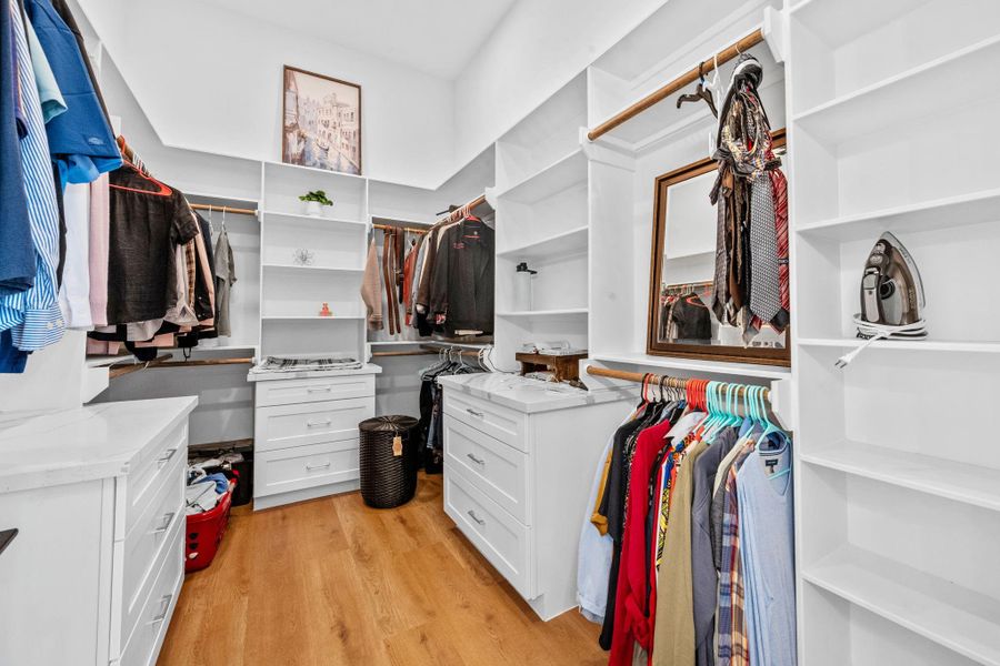 The oversized walk-in closet is a true luxury, fully equipped with custom built in shelving, drawers, and hanging racks to keep your wardrobe perfectly organized.