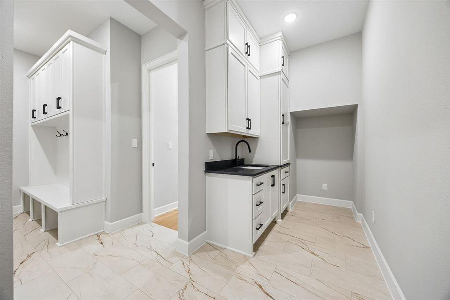 Mudroom featuring light marble finish floors and recessed lighting Mudroom featuring light marble finish floors and recessed lighting