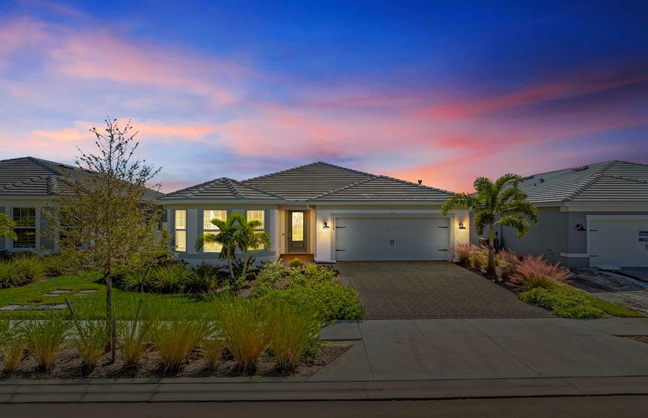Front exterior of a new home in TerraWalk at Babcock Ranch, Alva, FL, highlighting curb appeal (Image 25).