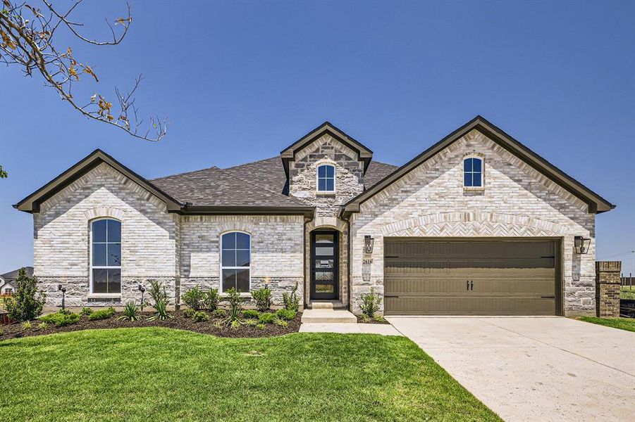 French country home with driveway, a front lawn, a garage, stone siding, and roof with shingles French country home with driveway, a front lawn, a garage, stone siding, and roof with shingles