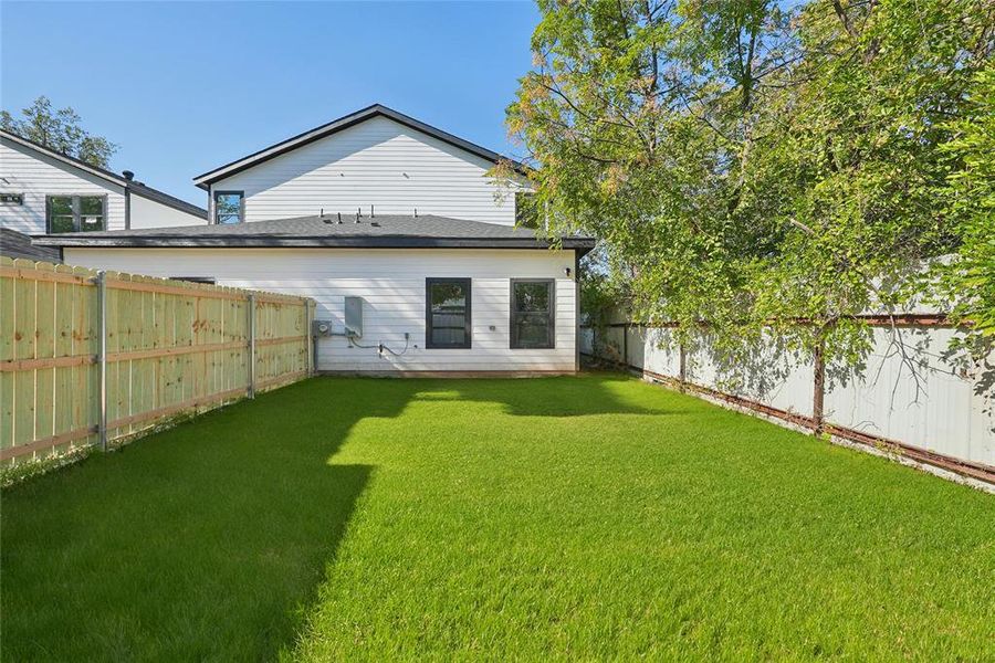 Rear view of property with a fenced backyard Rear view of property with a fenced backyard