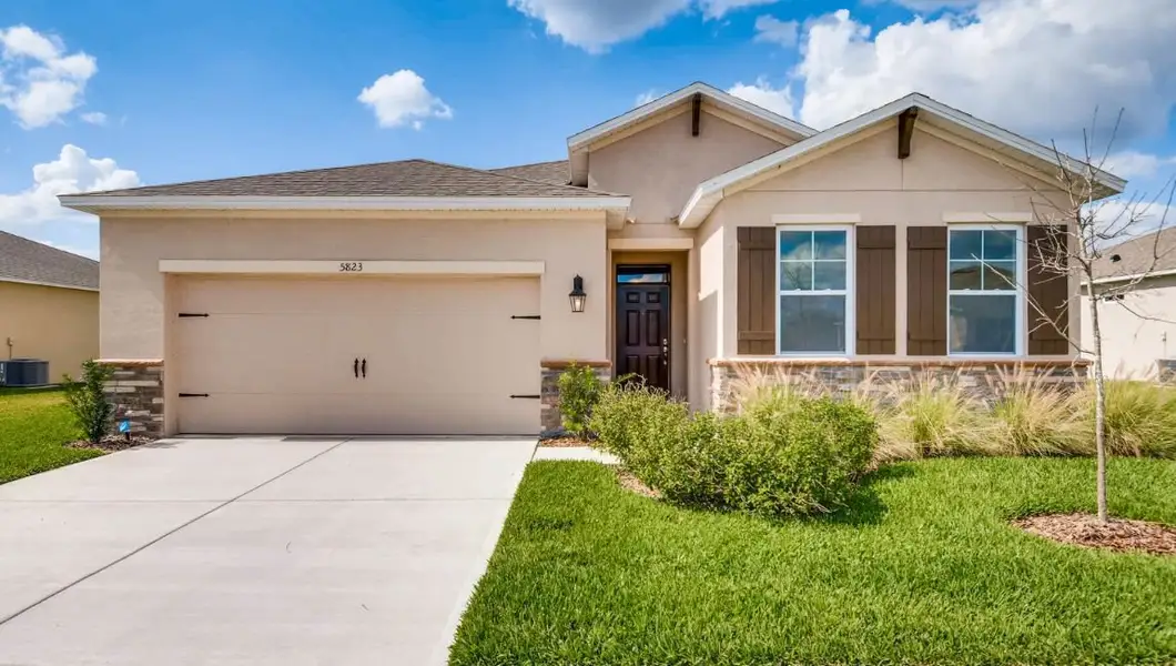Front exterior of a home in the Preserves at Lakeside Landings community, located in Winter Haven, FL (Image 9).