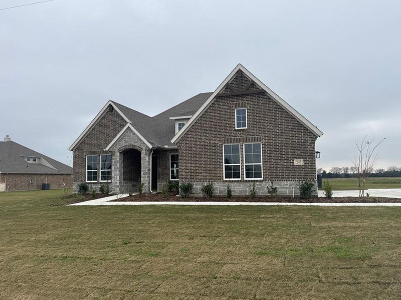 Front exterior of a new home in Fannin Ranch, Leonard, TX, highlighting curb appeal (Image 1). Front exterior of a new home in Fannin Ranch, Leonard, TX, highlighting curb appeal (Image 1).