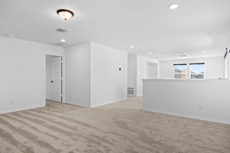 Unfurnished room featuring light colored carpet and recessed lighting