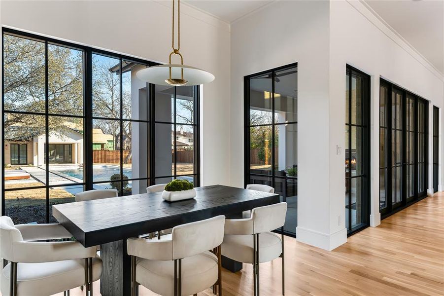 Dining area with crown molding and light wood-type flooring