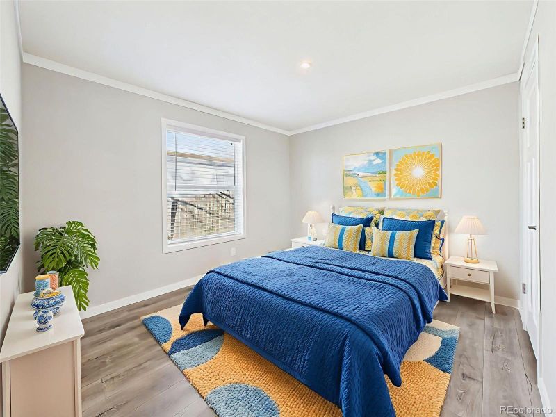 Virtually Staged Bedroom #3 – A cheerful and spacious bedroom setup with room for a full-size bed and additional furnishings, bathed in natural light from a large window.