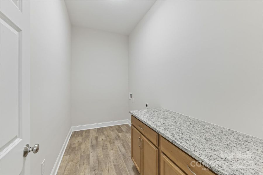 Laundry Room with built in cabinets & work space area!