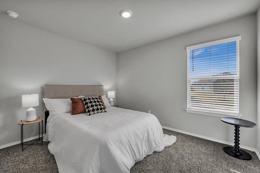 Bedroom 2 easily accommodates a queen sized bed (as shown) and features a generous walk-in closet.