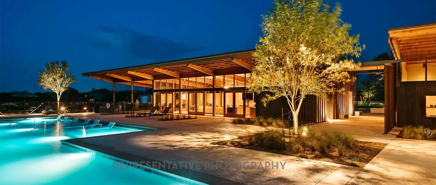 Pool at twilight featuring an outdoor pool and a patio area Pool at twilight featuring an outdoor pool and a patio area