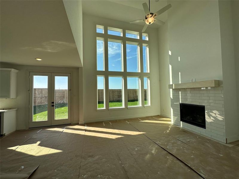 Bright and airy living room, where natural light pours through tall windows, creating an inviting, open space.