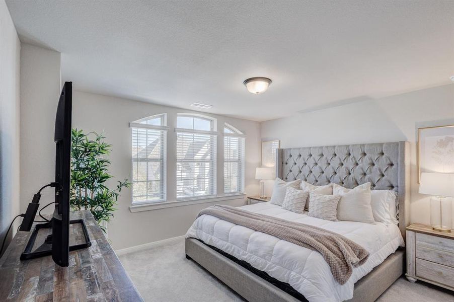 Upper Level Bedroom with carpet flooring and baseboards