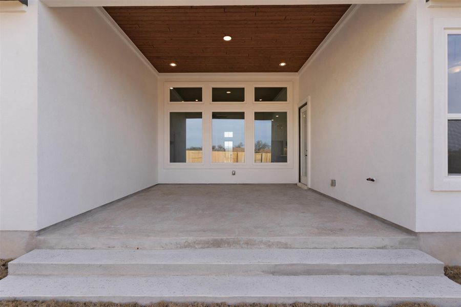 Entrance to property featuring stucco siding and a patio area