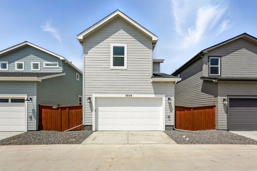 Front exterior of a new home in Farmlore, Brighton, CO, highlighting curb appeal (Image 2).