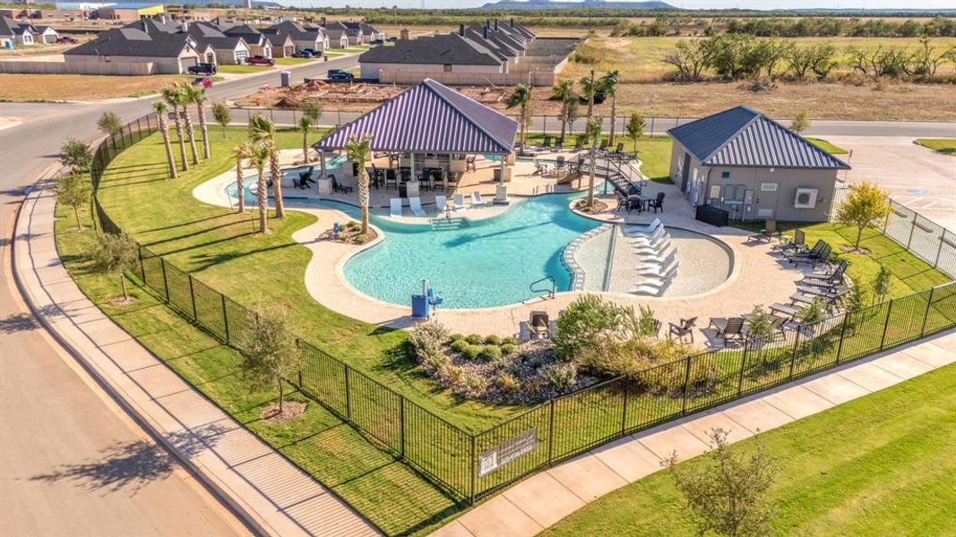 Community pool featuring a residential view, a patio area, a water play area, and a water slide