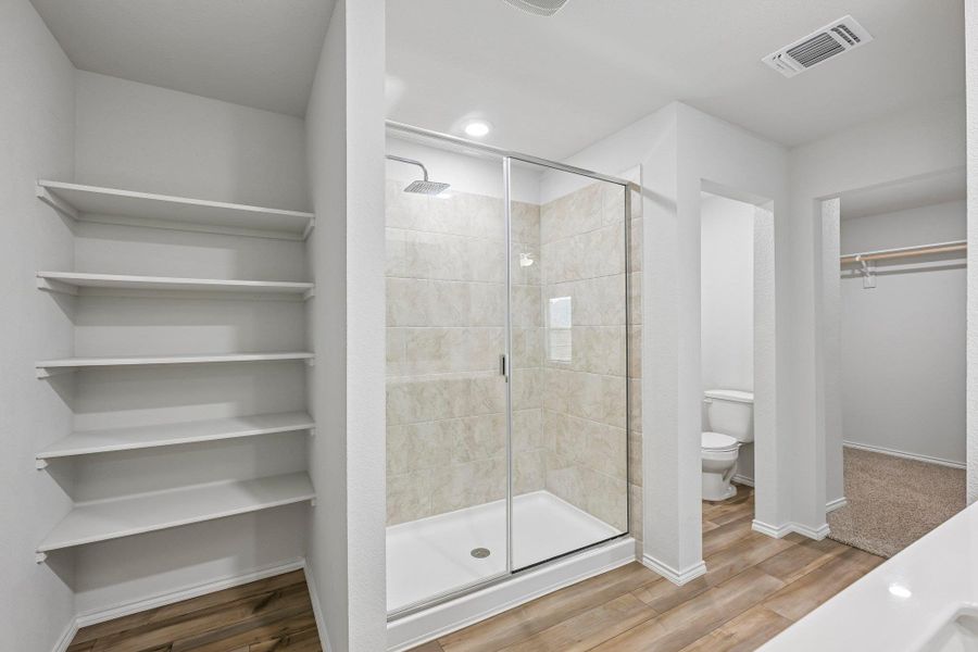 Bathroom featuring a glass-enclosed shower with tiled walls and a square rain showerhead