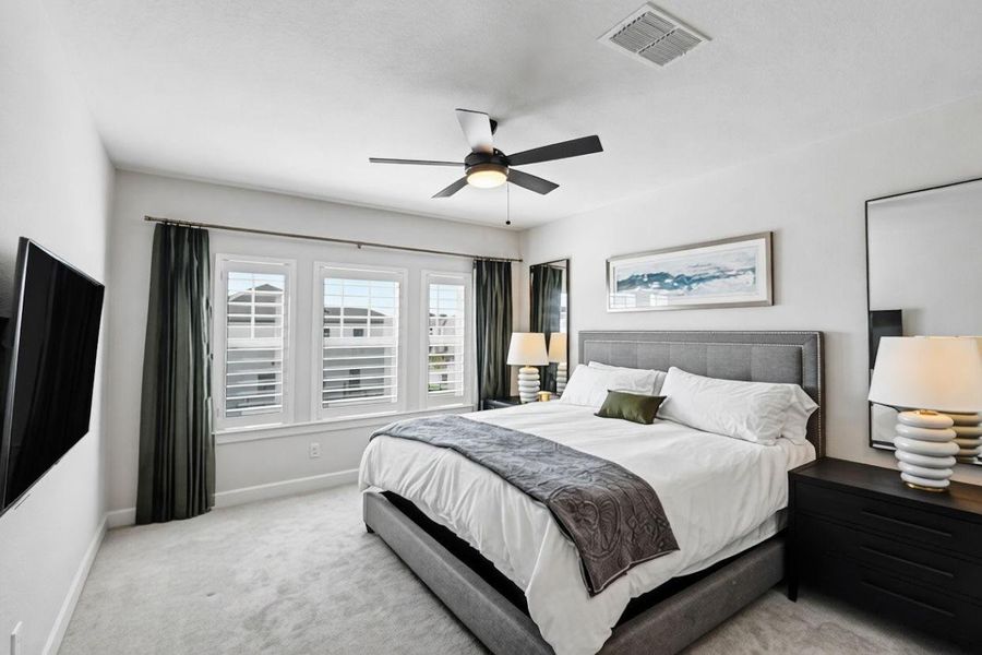 Spacious upstairs secondary bedroom with multiple windows for natural light—ideal for guests or a private home office.